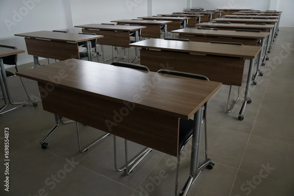 Fototapeta Classroom with many tables and chairs