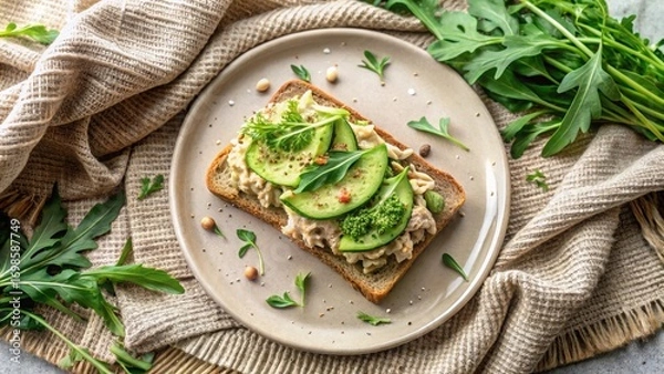 Fototapeta Aromatic and Wholesome Open-Faced Sandwich with Creamy Spread, Sliced Avocado, and Fresh Greens on Whole Grain Bread