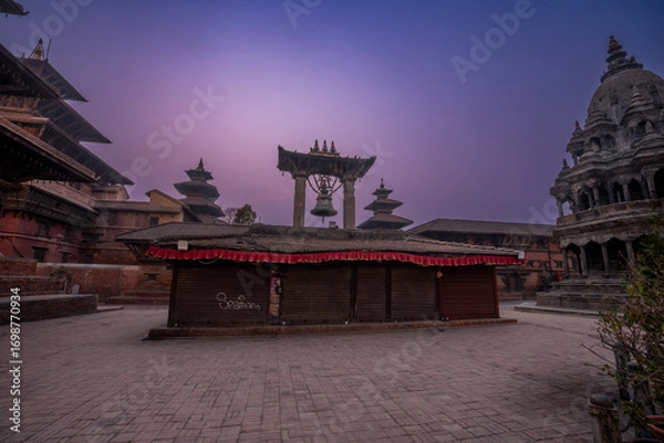 Fototapeta Magic view of Patan Durbar Square in Kathmandu, Nepal. Traditional Newari architecture with illuminated temples and purple sky. Historical UNESCO World heritage with cultural and architectural beauty.