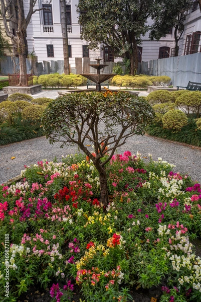 Fototapeta Tranquil view of the Garden of dreams in Kathmandu, Nepal. Beautiful landscaped garden with stone pathways, water fountains, blooming trees and elegant classical architecture offering a serene escape.