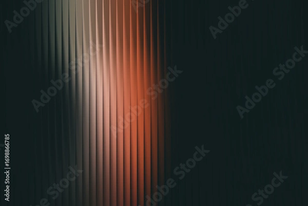 Fototapeta Abstract background featuring ribbed glass with a striking orange and white light flare against a dark, moody backdrop