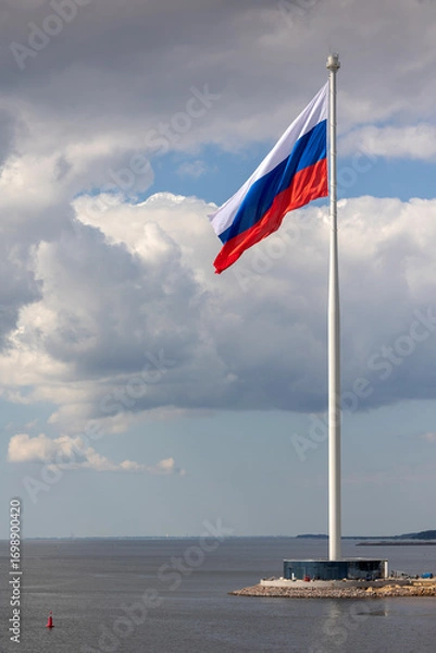 Obraz Flag of Russian Federation is flying in air on blue sky and white cumulus clouds. National flag of Russian. vertical photo.