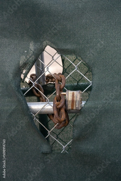 Fototapeta old rusty lock on a fence 