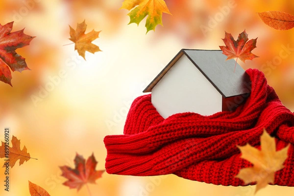 Fototapeta A house wrapped in a red scarf surrounded by autumn leaves