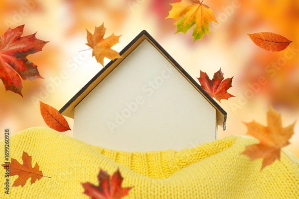 Fototapeta Warm and inviting home nestled in a soft sweater with leaves