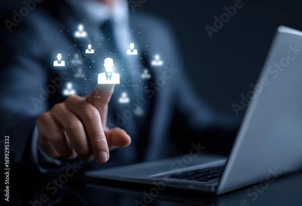 Fototapeta Businessman using laptop and touching virtual screen to select person for job position, recruitment and human resources concept