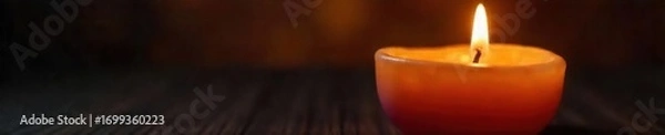 Fototapeta Close-up shot of a flickering candle, casting a warm, inviting glow in the dark, creating a tranquil and serene atmosphere, perfect for relaxation or meditation , yellow, atmosphere, darkness