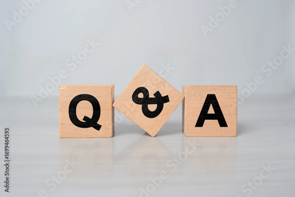 Fototapeta Q&A - acronym from wooden blocks with letters, questions and answers concept, top view on white background
