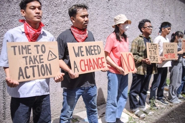 Fototapeta Determined Young People Stands Holding Protest Signs For Change And Action While Standing
