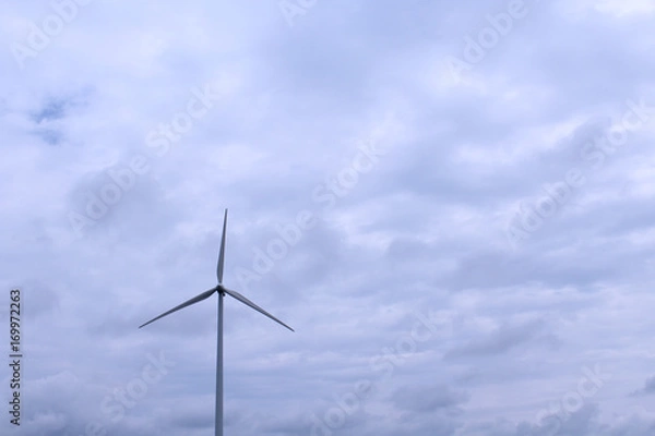 Fototapeta Dark Cloudy Day with Windmill on the Horizon