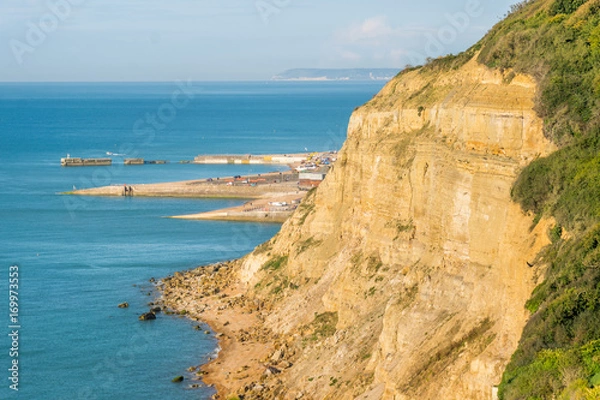 Fototapeta From Ecclesbourne Glen across blue sea English Channel site of proposed marina development to Hastings' beach