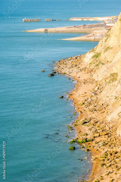 Fototapeta From Ecclesbourne Glen across blue sea English Channel site of proposed marina development to Hastings' beach