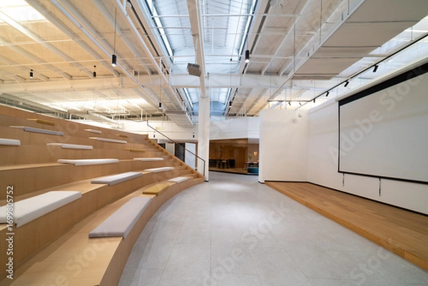 Fototapeta Modern office space with projection screen and tiered seating