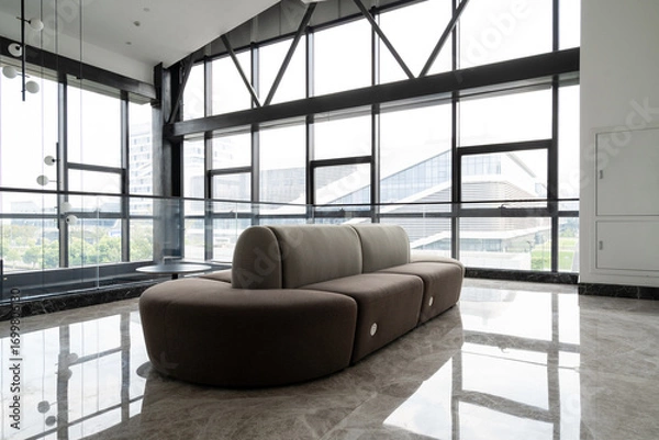 Fototapeta Modern lounge with  sofa and large windows
