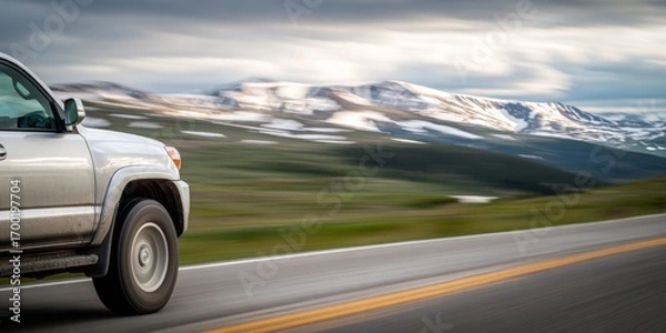 Fototapeta Silver suv driving on scenic mountain highway in summer