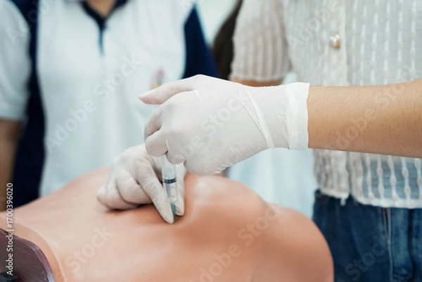 Fototapeta Nursing Student Practicing Injection with Training Model