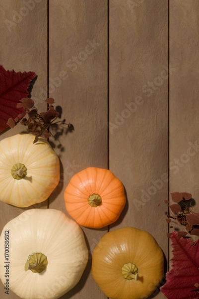 Obraz Autumn pumpkins with fall leaves on wooden background for thanksgiving decoration. 3d rendering
