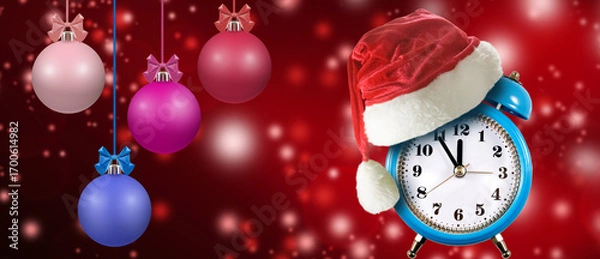 Fototapeta Festive clock wearing a Santa hat amidst colorful ornaments and sparkling lights for holiday celebrations