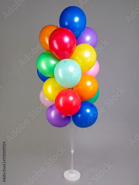 Obraz Multicolored balloons on white plastic stand isolated on gray background