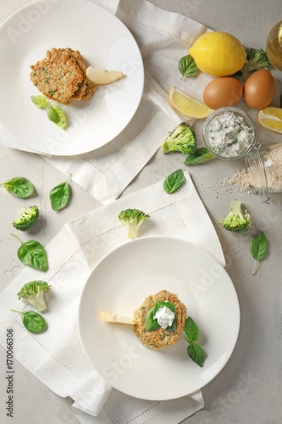 Fototapeta Composition with broccoli pancakes, lemon and basil leaves on table