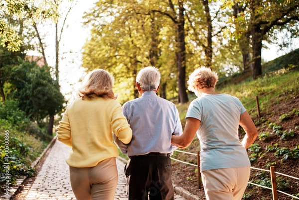 Fototapeta A Family Enjoying a Leisurely Walk in a Beautiful and Scenic Park This Autumn Season