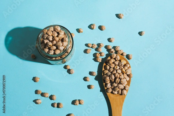 Obraz Flat lay photograph of natural cereals and grains, including oats, rice, and chickpeas, in a clean composition with natural light.