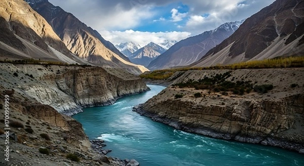 Fototapeta Majestic River Flowing Through a Grand Mountain Valley Landscape.