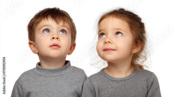 Fototapeta boy with inquisitive look gazing upward against ultrabright white background embodies sense of anticipation
