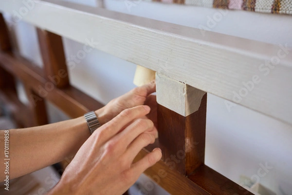 Fototapeta Engage in DIY chair restoration using a paint brush and protective gloves for the process