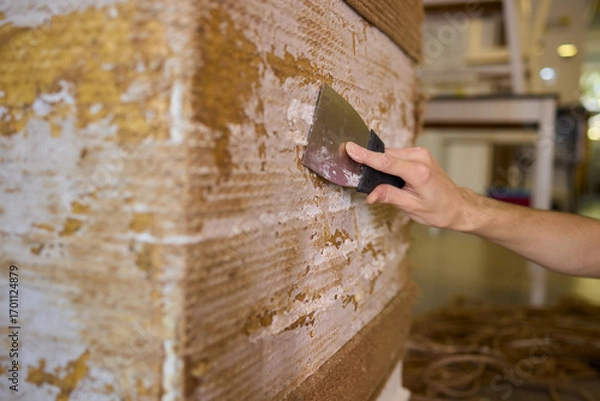 Fototapeta Applying Putty on a Wall Surface Using a Scraper Tool for a Smooth Finish and Texture