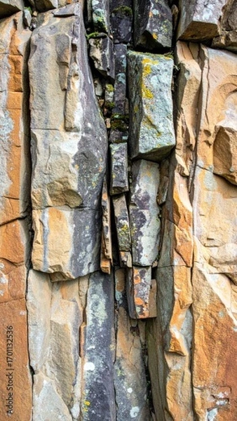 Fototapeta Textured Rock Face with Moss and Cracks a Natural Formation Background Close Up Detail of Earth Tone Mineral