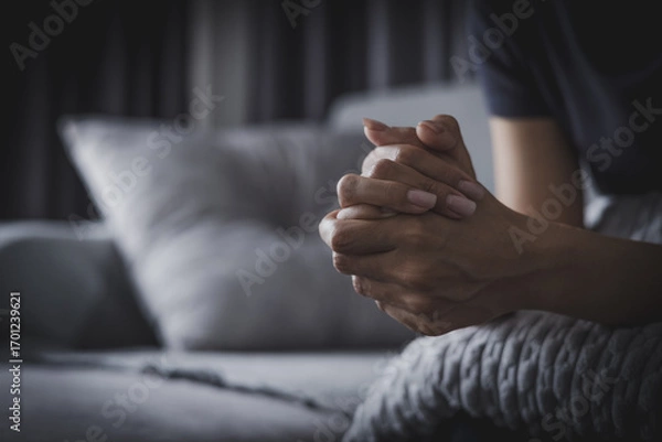 Fototapeta woman's hands clasped together in a moment of prayer or deep contemplation showcasing inner thoughts.
