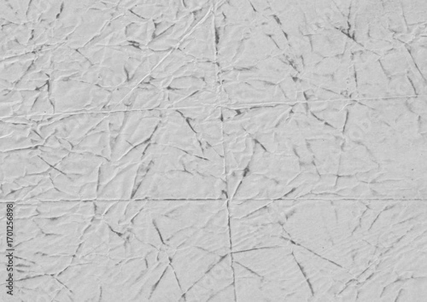 Fototapeta Crumpled paper texture with wrinkles and folds. Grunge rough surface with stains for overlay design.