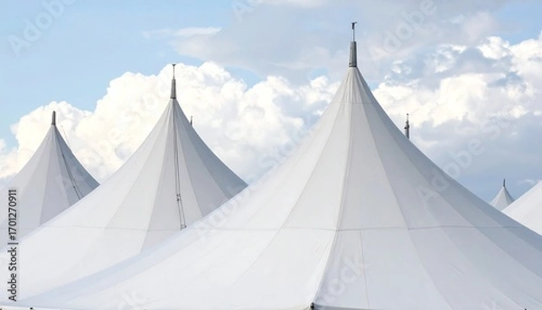 Fototapeta Several large, white event tents stand tall against a partly cloudy sky.