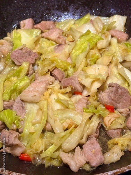 Obraz Stir-fried pork belly with cabbage and fish sauce, Thai wok stir-fry, garlicky umami; home-cooking close-up background with copy space