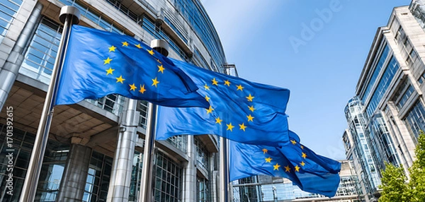 Fototapeta European Union Flags Waving Outside a Modern Building Under Clear Blue Sky During Daylight in a Bustling City
