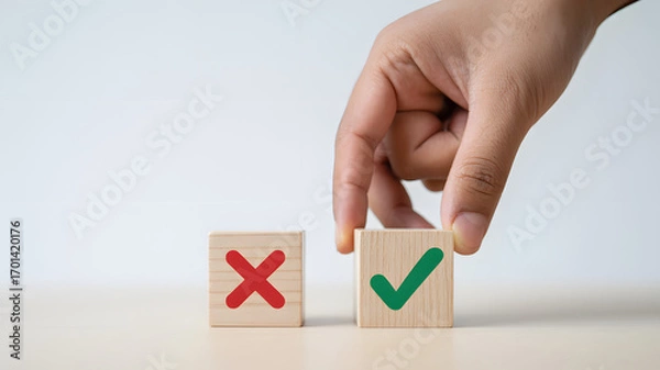 Obraz Hand chooses green checkmark over red X on wooden blocks, symbolizing right decision making process