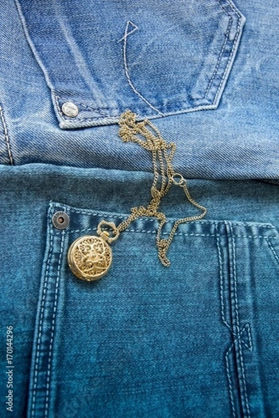 Obraz Dense blue denim fabric and Gold chain with a clock suspension with a curly cover