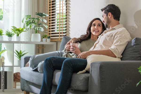 Fototapeta Couple talking and relaxing at home, enjoying lifestyle and happy relationship together with love and open communication.