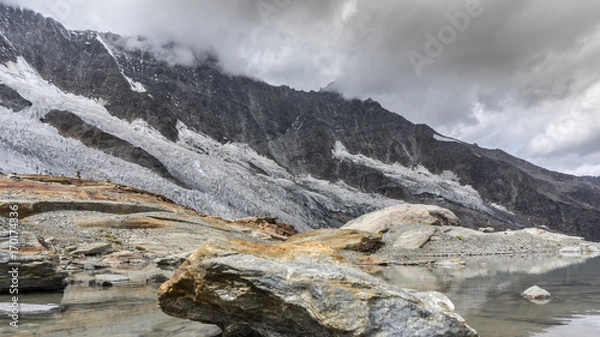 Fototapeta A beautiful mountin group (Mischabel group) covered in clouds in the alps of switzerland