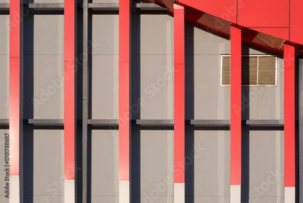 Fototapeta Geometric lines pattern background of red shading fins and aluminium composite tiles with sunlight and shadow on gray modern exterior building wall decoration in minimal design