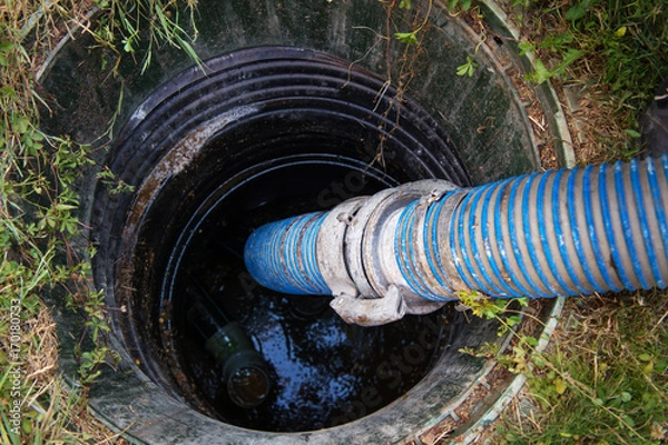 Obraz Emptying household septic tank. Cleaning sludge from septic system.