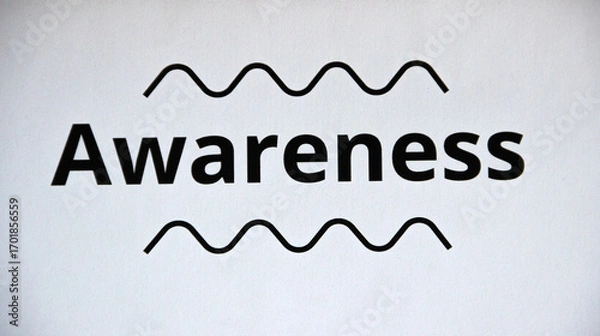 Fototapeta Extreme close up of the word 'awareness' on white paper sheet, isolated