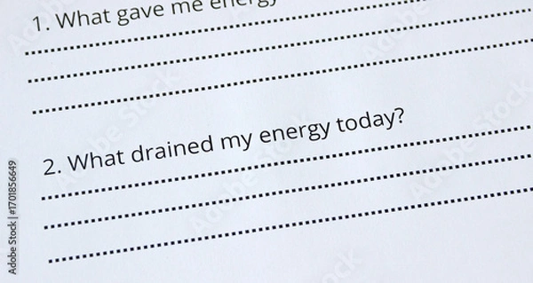 Fototapeta Extreme close-up of a question on a sheet of paper 'What drained my energy today?'. Self-reflection question, therapy, psychology, self-awareness, mindfulness concept, journaling