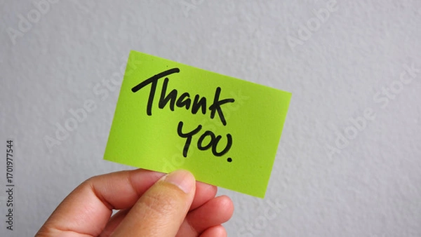 Obraz Hand holding thank you,  sticky note on white background.
