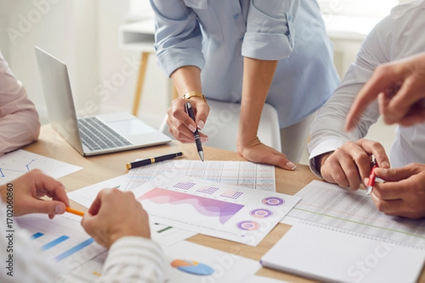 Fototapeta Cropped photo of business people discussing company finance growth with brainstorming analyzing data stat. Company employees working on a meeting with financial documents together. Teamwork concept.