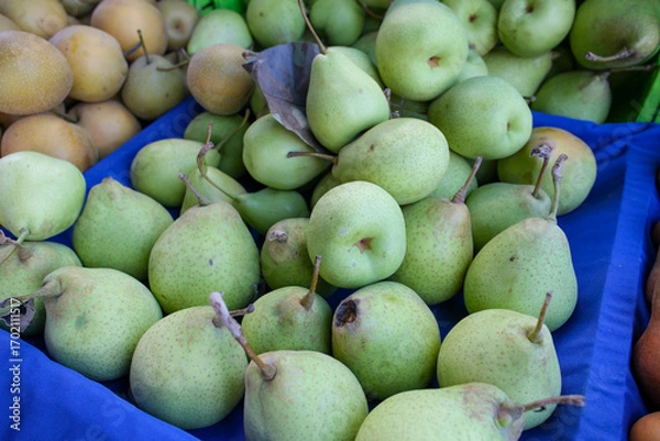 Obraz Green pears on blue cloth