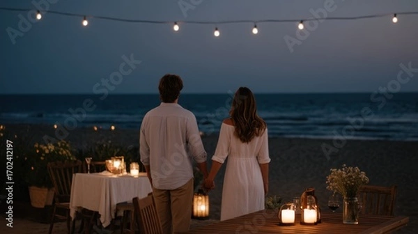 Obraz Romantic Beach Dinner at Sunset with Soft Lights and Elegant Table Setting for Couples