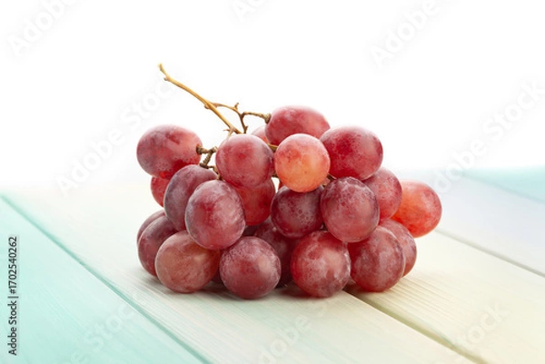 Fototapeta red grape on wood background on white