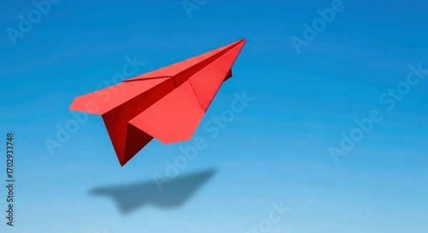 Fototapeta Bold red paper airplane soars through a clear blue sky inspiring dreams of travel, innovation, and fresh perspectives for a bright, limitless future of success